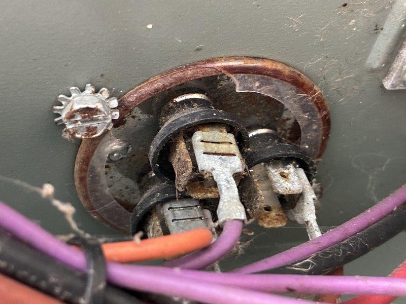 Completed comprehensive AC tune-up and system inspection. During the service, identified severe corrosion and deterioration on electrical connections within the outdoor disconnect box, including heavily rusted terminals, corroded mounting plates, and degraded wire connectors indicating prolonged moisture exposure. Inspected refrigerant line set penetrations at foundation level, noting weathered line insulation and copper piping with natural patina from outdoor exposure; confirmed proper line set routing through landscaping area with adequate mulch coverage for ground contact protection.