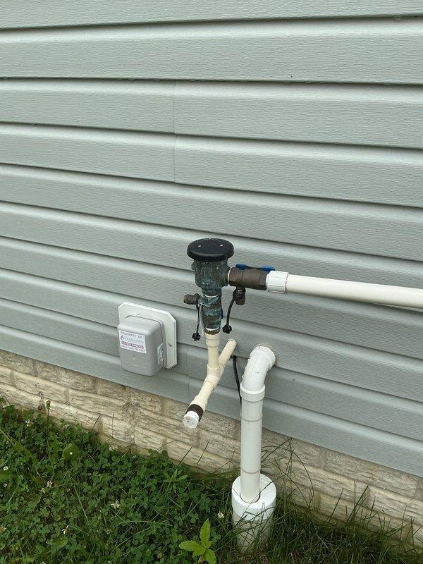 Performed annual backflow prevention device testing on irrigation system as required by municipal water authority. Inspected RPZ (Reduced Pressure Zone) backflow preventer assembly mounted on exterior wall, noting significant oxidation and patina on brass components. Conducted standard test procedures including check valve functionality, relief valve operation, and differential pressure measurements. Verified proper operation of test cocks and shutoff valves. Documented all test results and completed municipal compliance certification form for submission to city water department. Unit passed inspection and remains in acceptable working condition despite exterior corrosion. Photographed installation for service records.