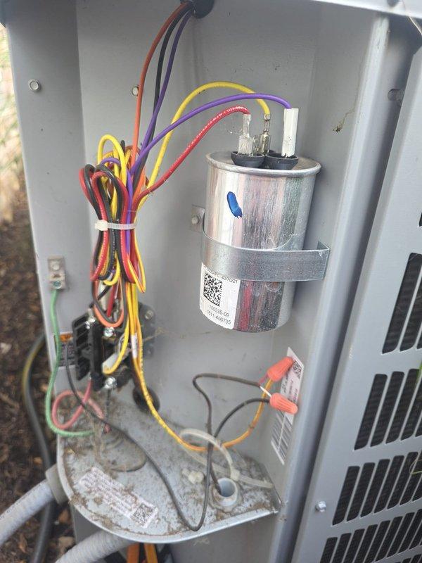# HVAC Maintenance - Cooling

Performed routine preventive maintenance cooling visit on residential air conditioning system. Conducted comprehensive inspection of outdoor condensing unit, including visual examination of electrical disconnect box and internal components. Verified proper operation of disconnect switch and inspected exterior wiring connections and conduit routing.

Removed access panel to assess internal electrical and mechanical components. Inspected dual-run capacitor for proper operation, checking for signs of bulging, leakage, or deterioration. Verified secure mounting bracket and examined electrical terminal connections for tightness and corrosion. Confirmed capacitor labeling and documentation remained legible.

Evaluated electrical wiring harness, noting proper color-coded wire routing and secure zip-tie management. Checked all wire connections including orange, purple, yellow, and red conductor terminations. Inspected low-voltage control wiring and sensor probe co