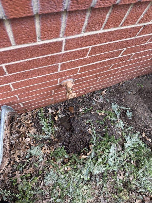 Replaced rear exterior hose bib (faucet) on brick structure. Accessed copper supply line through interior ceiling plenum, cut and soldered new copper piping connections to install frost-free sillcock. Verified proper drainage slope and sealed exterior wall penetration to prevent water intrusion.