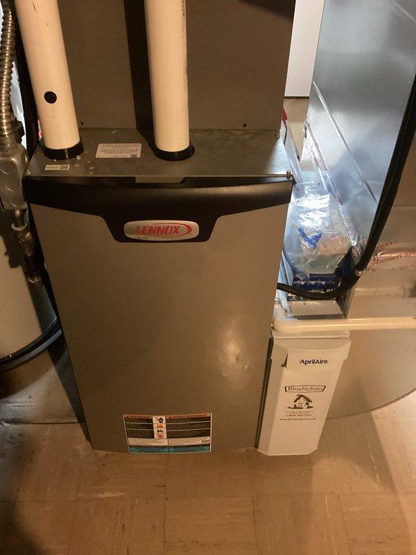# No Cool Service - Residential HVAC System

Responded to service call for complete loss of power to thermostat (Model S86NMU) following overnight power outage. Upon arrival, confirmed no display or power at thermostat location. Inspected Lennox furnace system and associated control board in basement utility room. 

Traced electrical circuits from thermostat through low-voltage wiring to furnace control panel. Opened furnace control panel and visually inspected green control board for signs of power surge damage, including burned components, damaged traces, or failed transformers. Checked all wire connections at control board terminals for secure attachment and proper seating in white connector blocks.

Tested 24VAC transformer output and verified proper voltage supply to control circuit. Examined heat sink assembly and power components on left side of control board for thermal damage or failure. Inspected all colored wire bundles (blue, yellow, red, white, black) for continuity and pr