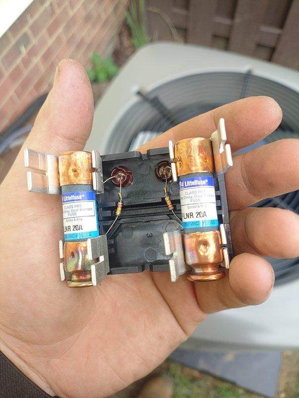 Completed first-time air conditioning and evaporator coil installation. Installed new AC condensing unit with proper refrigerant line connections, service valves with brass fittings, and dual fuse protection assembly for electrical safety. Verified all refrigerant line connections are secure with appropriate insulation on suction line, confirmed proper valve operation, and ensured electrical components including Littelfuse fuses are properly installed and functioning for system protection.