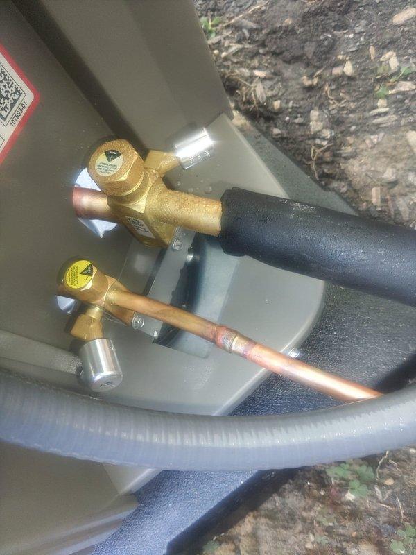 Completed first-time air conditioning and evaporator coil installation. Installed new AC condensing unit with proper refrigerant line connections, service valves with brass fittings, and dual fuse protection assembly for electrical safety. Verified all refrigerant line connections are secure with appropriate insulation on suction line, confirmed proper valve operation, and ensured electrical components including Littelfuse fuses are properly installed and functioning for system protection.