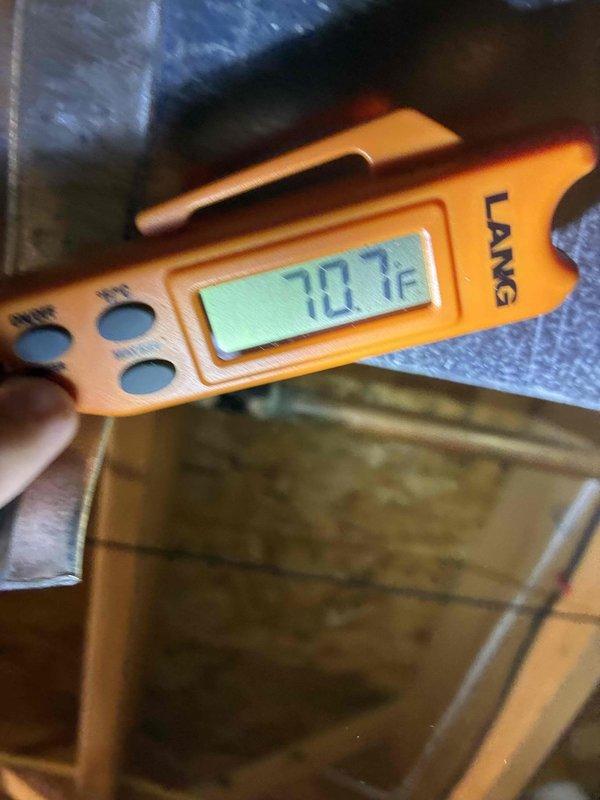 Completed MVP cooling maintenance visit on 4-year-old system. Performed comprehensive inspection of outdoor condensing unit, noting weathering and dirt accumulation on exterior panels and grilles consistent with normal outdoor exposure. Verified temperature readings at indoor air handler in attic space, measuring 70.7°F supply air temperature. Confirmed unit operational with proper airflow through condenser coils despite surface debris. System functioning within normal parameters for routine preventive maintenance service.