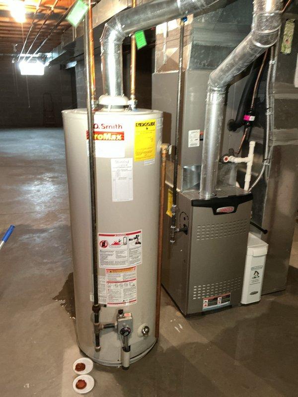 Responded to emergency call for water heater failure with active leak in basement. Upon arrival, found existing A.O. Smith tanked water heater experiencing catastrophic failure with water damage to surrounding area. Completed full water heater replacement, installing new unit with proper copper piping connections, expansion tank, and code-compliant plumbing infrastructure. System tested and verified operational with no leaks detected.