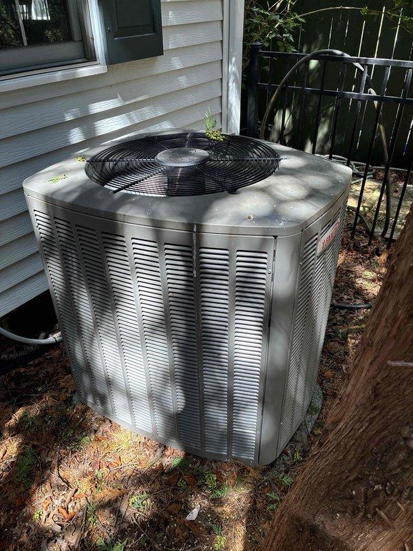 Completed comprehensive AC maintenance certification service check on residential cooling system less than five years old. Unit exterior showed moderate dirt accumulation and organic debris buildup on condenser panels and coils. Performed standard maintenance protocol including visual inspection of condenser unit, verified proper operation of all components, and documented equipment condition with photographs for certification records.