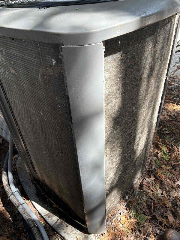 Completed comprehensive AC maintenance certification service check on residential cooling system less than five years old. Unit exterior showed moderate dirt accumulation and organic debris buildup on condenser panels and coils. Performed standard maintenance protocol including visual inspection of condenser unit, verified proper operation of all components, and documented equipment condition with photographs for certification records.