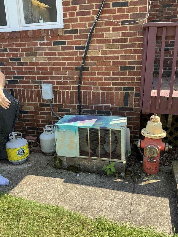 Conducted comprehensive site assessment for whole-house HVAC upgrade consultation. Evaluated existing 4-year-old furnace in basement and inspected aged outdoor condenser unit showing significant weathering, rust staining, and discoloration on housing and top panel. Assessed feasibility of converting single-zone system to dual-zone configuration to accommodate upstairs rooms currently served by non-functional secondary unit. Documented existing equipment condition, ductwork infrastructure, and outdoor installation space to develop recommendations for complete system replacement with zoned climate control capabilities.