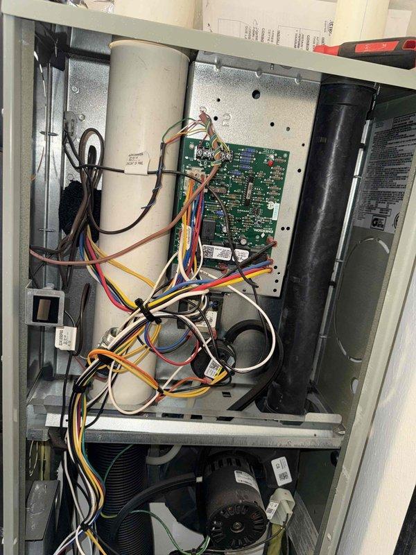 Completed MVP cooling maintenance visit on 10-12 year old HVAC system. Performed comprehensive system inspection with access panel removed to evaluate internal components including control board, capacitors, blower motor assembly, and electrical connections. All wiring verified secure with proper color-coded connections and zip tie management in place. Conducted electrical diagnostics using digital multimeter, recording 89.7 AC inrush current reading to assess compressor and motor performance. Control board, transformer, and all internal components found operating within normal parameters with no signs of deterioration or failure.