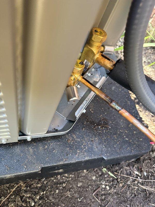 Completed installation of air conditioning system with evaporator coil as part of a secondary HVAC job. Installed outdoor condensing unit on composite equipment pad with proper leveling and positioning, connected refrigerant line sets with insulated suction line, and installed brass service valve assembly with copper piping connections for system access and maintenance. Verified all electrical connections per manufacturer wiring diagrams and specifications, ensuring proper voltage supply and control wiring integration. System positioned for optimal airflow and serviceability with all components secured and protected according to installation standards.
