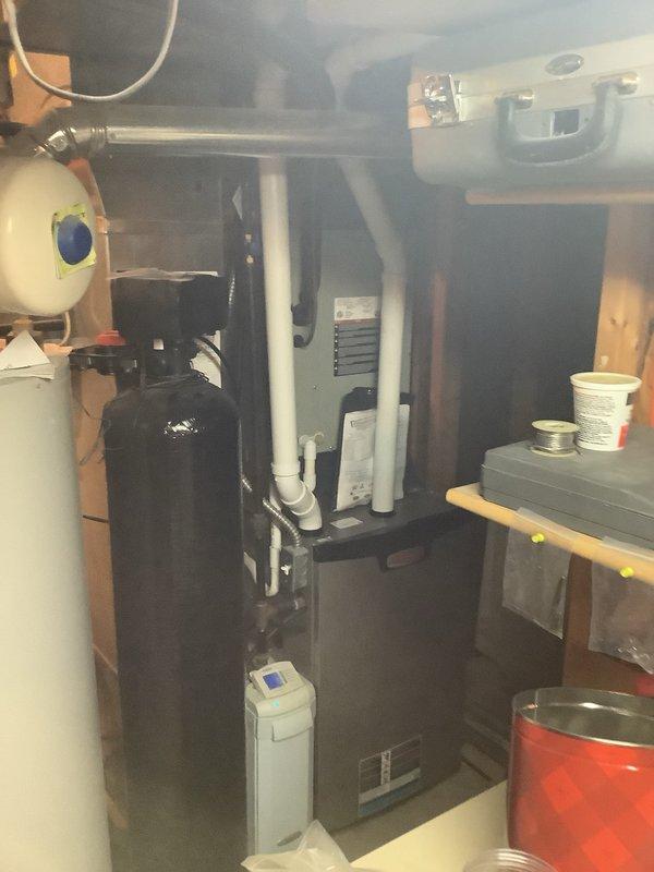 Completed installation of air conditioning condenser unit and evaporator coil system as secondary installation. Positioned outdoor condenser unit on concrete pad against exterior wall with proper clearances, established refrigerant line connections, and verified electrical connections to disconnect box. Indoor evaporator coil integrated with existing furnace system in mechanical room, with condensate drain lines properly routed to existing plumbing infrastructure.