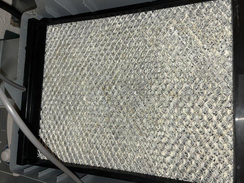 Completed comprehensive AC tune-up on seven-year-old air conditioning system. Performed standard maintenance inspection including filter assessment, which showed moderate dust accumulation and debris collection across mesh surface. Inspected control board and electrical connections, verifying all wire terminations secure and circuit board components functioning properly. System operational and ready for cooling season.