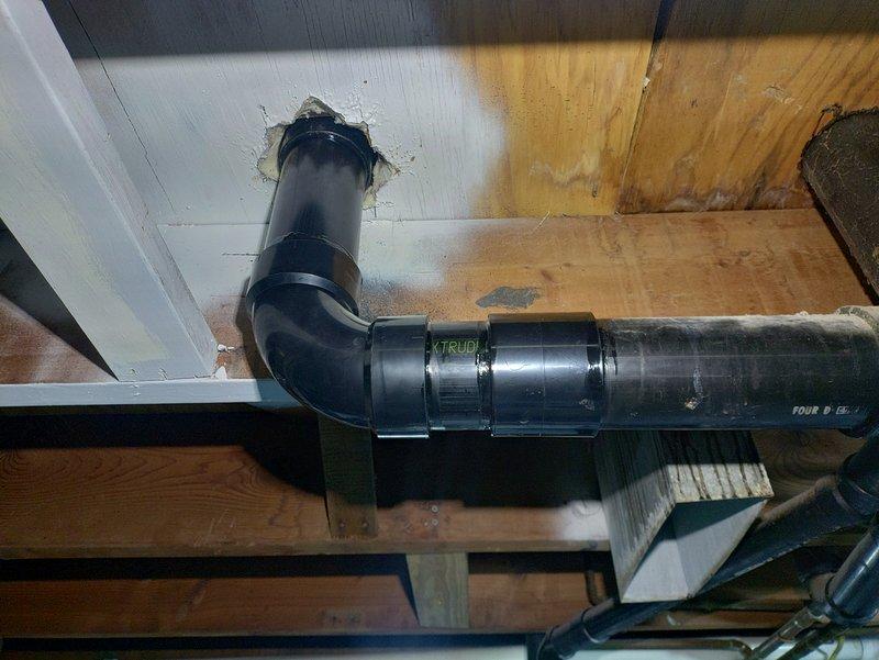 Repaired leaking toilet flange in bathroom by removing existing toilet and cutting out damaged ABS drain line to sound connection point. Installed new ABS piping and fittings from tie-on point to new toilet flange, which was securely fastened to subfloor. Reset toilet with new wax ring and mounting bolts, then performed leak test to verify proper operation and confirm no water discharge from connections.