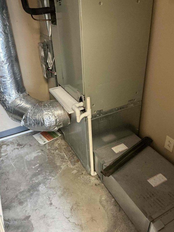 Provided estimate for replacement of 20+ year old 5-ton geothermal heat pump system that is no longer cooling. Assessed existing ground-source unit, air handler, and associated ductwork in mechanical room. Documented heavily corroded and deteriorated ground loop valves showing extensive rust and aging infrastructure. Recommended complete system replacement due to age and condition of equipment.