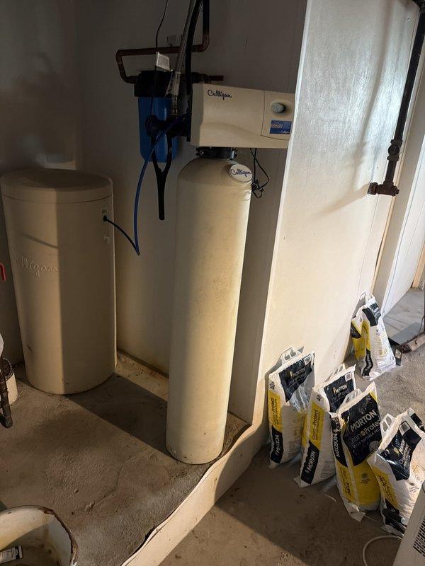 Responded to service call for non-functional water softener system that had been inoperative for approximately one week. Upon arrival, inspected existing water treatment installation consisting of Whirlpool and Culligan tanks with associated control valve assembly and wall-mounted blue filter housing. Evaluated system components including pressure tank, piping connections, and control mechanisms to diagnose failure and restore proper water softening functionality.