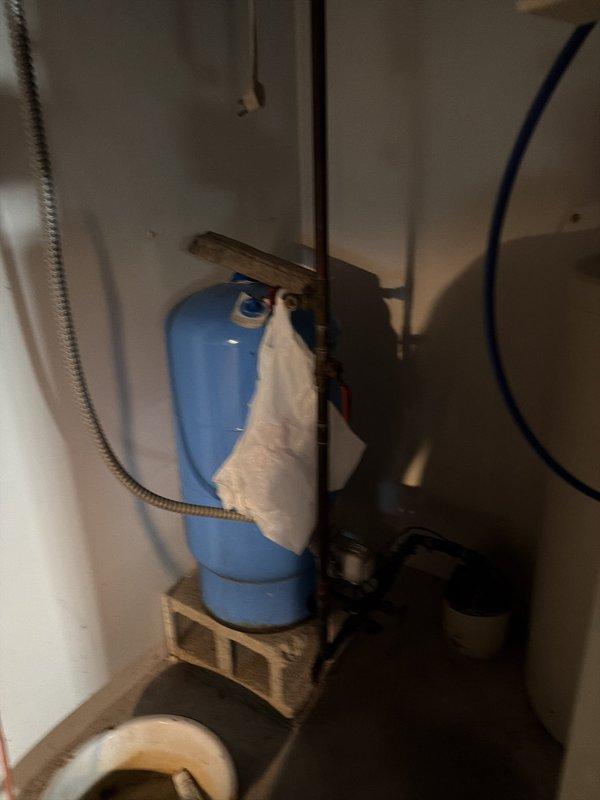 Responded to service call for non-functional water softener system that had been inoperative for approximately one week. Upon arrival, inspected existing water treatment installation consisting of Whirlpool and Culligan tanks with associated control valve assembly and wall-mounted blue filter housing. Evaluated system components including pressure tank, piping connections, and control mechanisms to diagnose failure and restore proper water softening functionality.