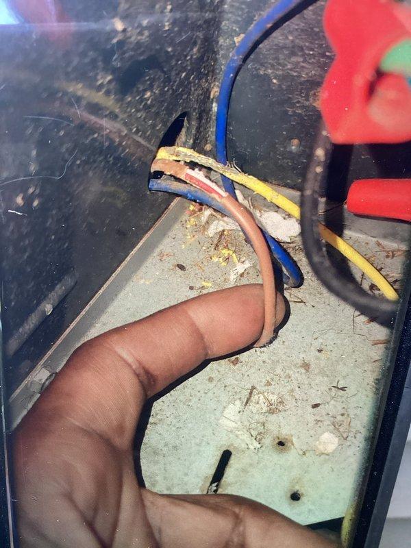 Completed scheduled cooling maintenance visit on 13-year-old HVAC system. Inspected electrical disconnect panel and identified signs of age-related wear, heat discoloration, and charring near wire entry points at the base of the enclosure. Examined internal wiring connections, terminal screws, and bus bar assembly for proper contact and potential safety concerns. Performed necessary electrical connection assessment and documented condition of disconnect mechanism and associated wiring for maintenance records.