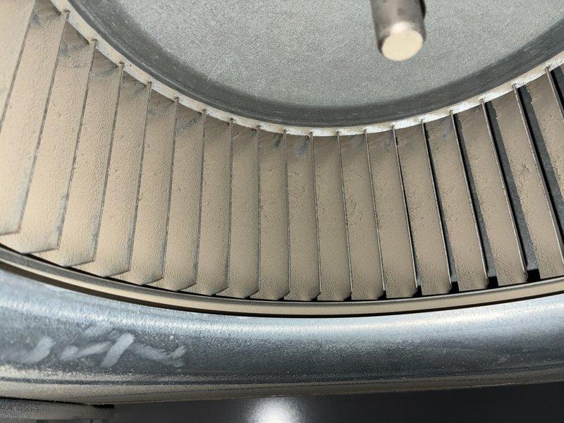 Responded to no cooling complaint on 9-year-old air conditioning system. Upon inspection, found evaporator coil heavily contaminated with dust, lint, and debris accumulation restricting airflow. Blower wheel assembly also showed significant dirt buildup on blades affecting system performance. Cleaned evaporator coil fins and blower wheel, removing accumulated debris to restore proper airflow and cooling capacity. System tested and operating normally upon completion.
