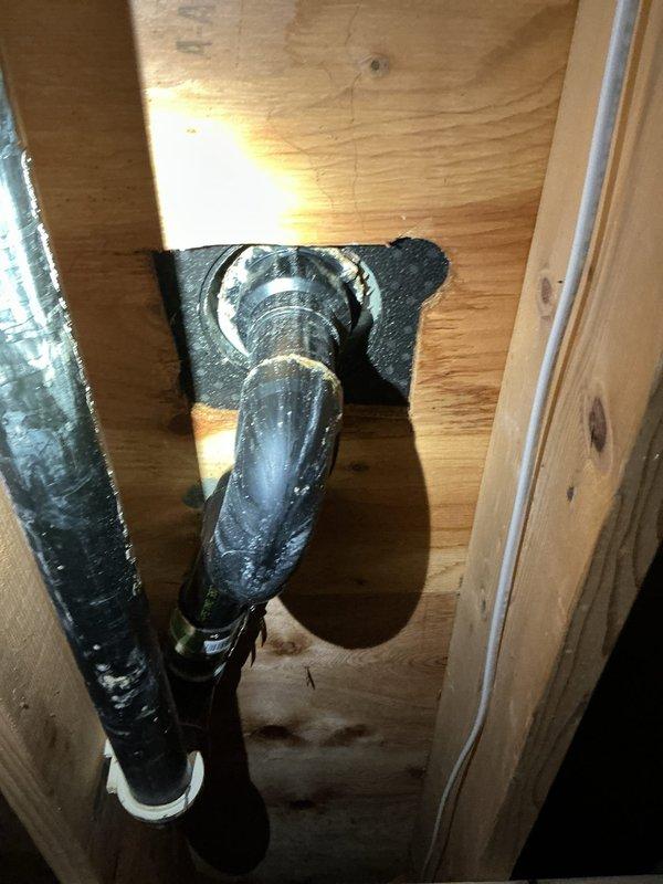 Responded to drain pipe maintenance call for shower in 40-year-old home where previous repair from two years ago had failed. Upon inspection, found bathtub drain assembly showing significant buildup and discoloration around lower drain fitting, with debris accumulation affecting proper drainage. Accessed crawlspace area to inspect drain line routing and connections through floor structure. Cleared obstruction from shower drain, removed accumulated debris and buildup from drain fittings, and verified proper water flow through drain system. Tested drain operation to ensure complete resolution of drainage issue.