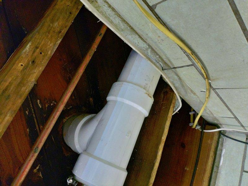 Completed warranty repair to address minor leak in drain line connection on previously repaired main sewer line. Sourced and staged necessary replacement parts from multiple suppliers to ensure proper materials were available for repair. Replaced faulty PVC drain fittings and connections, including curved elbow joints and P-trap assembly. Verified proper sealing at all pipe joints and couplings to eliminate leak. Inspected surrounding plumbing infrastructure, including connections between PVC and copper piping with metal couplings. Tested system for proper drainage flow and confirmed no additional leaks present. All repairs completed to code specifications with warranty coverage applied.