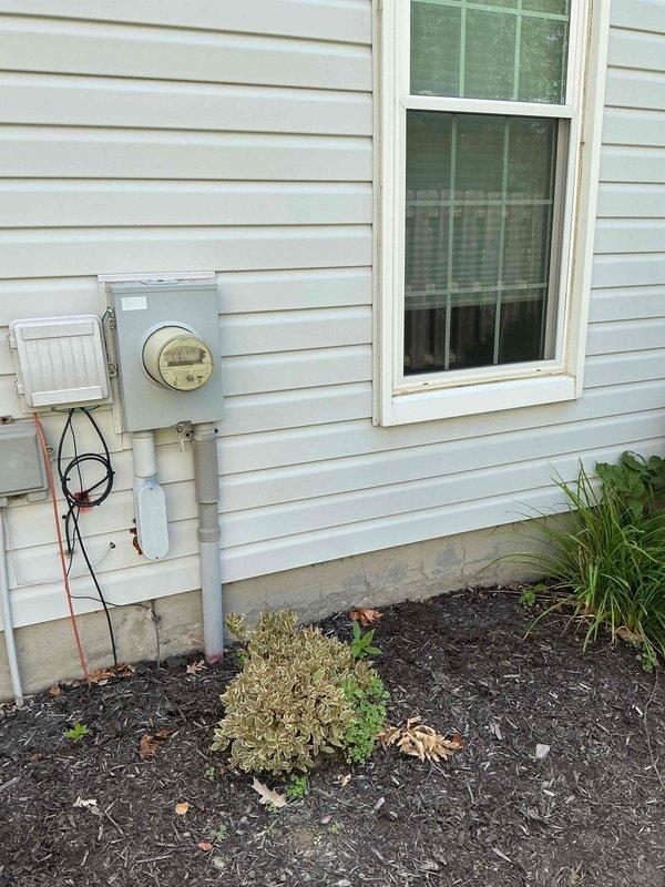 Conducted site evaluation for Generac standby generator installation at residential property. Assessed existing electrical service, meter location, and available installation area on exterior wall. Documented current electrical panel configuration and service entrance conduit routing to determine transfer switch placement and load requirements. Photographed proposed generator pad location considering clearances from windows, utility meters, and landscaping features to ensure compliance with manufacturer specifications and local code requirements.