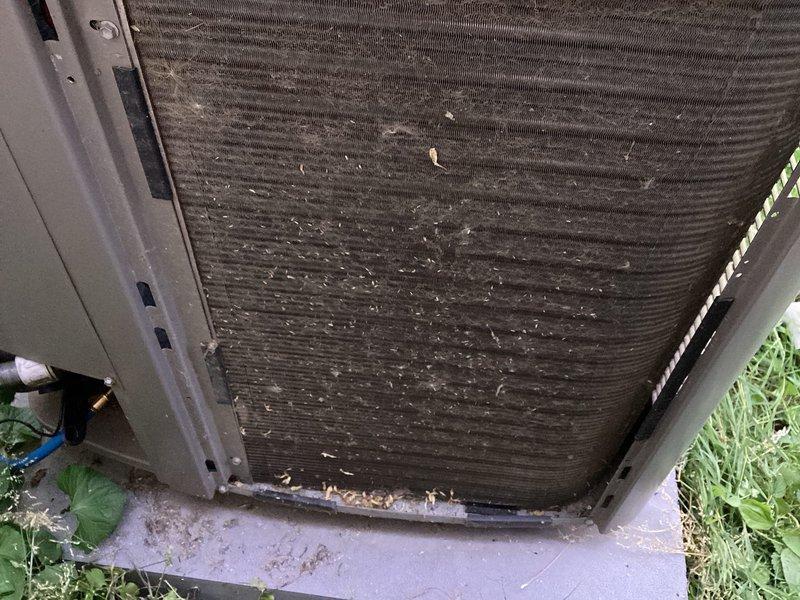 Performed scheduled maintenance visit for MVP customer's air conditioning system. Upon inspection, found outdoor condenser coil heavily clogged with dirt, dust, and debris, significantly restricting airflow and reducing system efficiency. Cleaned condenser coil fins thoroughly to remove accumulated buildup and restore proper airflow. Inspected indoor air handler unit and associated components, including humidifier and ductwork connections, confirming all equipment is in functional and well-maintained condition with no visible damage or deterioration.