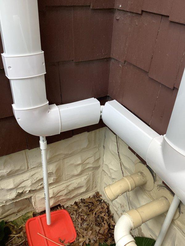 Responded to service call regarding incomplete mini split installation with faulty condensate drain. Inspected exterior wall penetration and drainage system, verified proper PVC condensate line routing from indoor unit through foundation area, and confirmed secure mounting with appropriate fittings and elbow joints. Corrected condensate drain spout positioning to ensure proper drainage away from structure, tested system operation to verify condensate flow, and documented completed installation with exterior drainage components functioning as designed.
