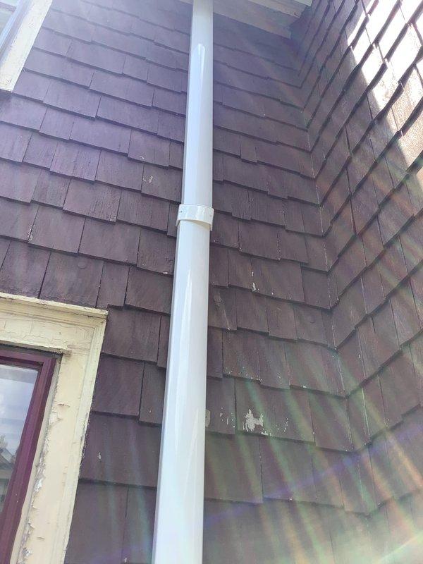 Responded to service call regarding incomplete mini split installation with faulty condensate drain. Inspected exterior wall penetration and drainage system, verified proper PVC condensate line routing from indoor unit through foundation area, and confirmed secure mounting with appropriate fittings and elbow joints. Corrected condensate drain spout positioning to ensure proper drainage away from structure, tested system operation to verify condensate flow, and documented completed installation with exterior drainage components functioning as designed.