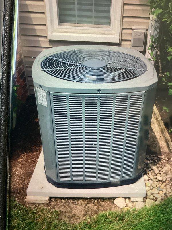 Performed comprehensive cooling system maintenance on residential outdoor condenser unit. Conducted visual inspection of unit exterior, verified proper placement on concrete pad, and checked surrounding clearances for adequate airflow. Inspected fan guard assembly, louver vents, and electrical disconnect box for proper operation and secure mounting. Unit found in serviceable condition with no immediate repairs required. All components functioning within normal parameters at time of service.