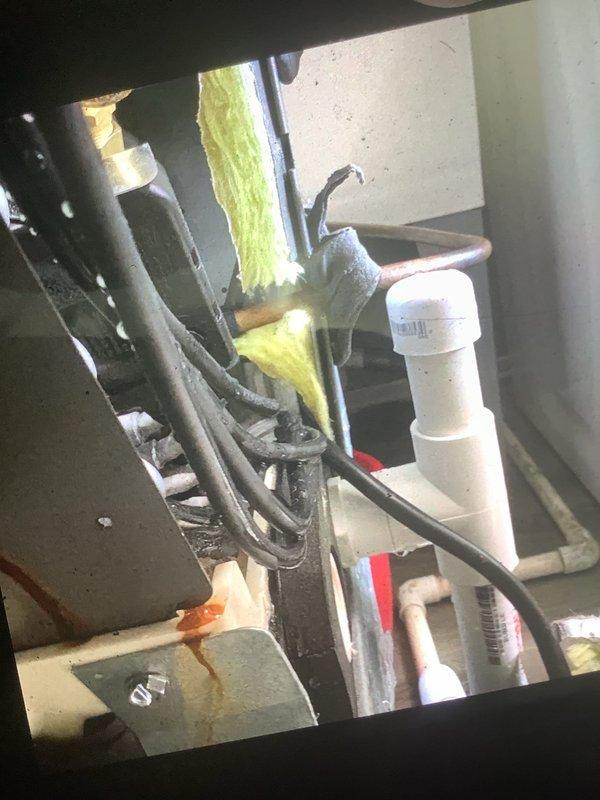 Responded to service call for water leaking from newly installed air conditioning unit in laundry room. Upon inspection, identified improper condensate drain line installation with inadequate pitch and connection issues at the PVC drain assembly. Corrected drain line configuration, ensured proper slope for gravity drainage, and secured all connections to eliminate the water leak. System tested and verified no further water discharge from unit.