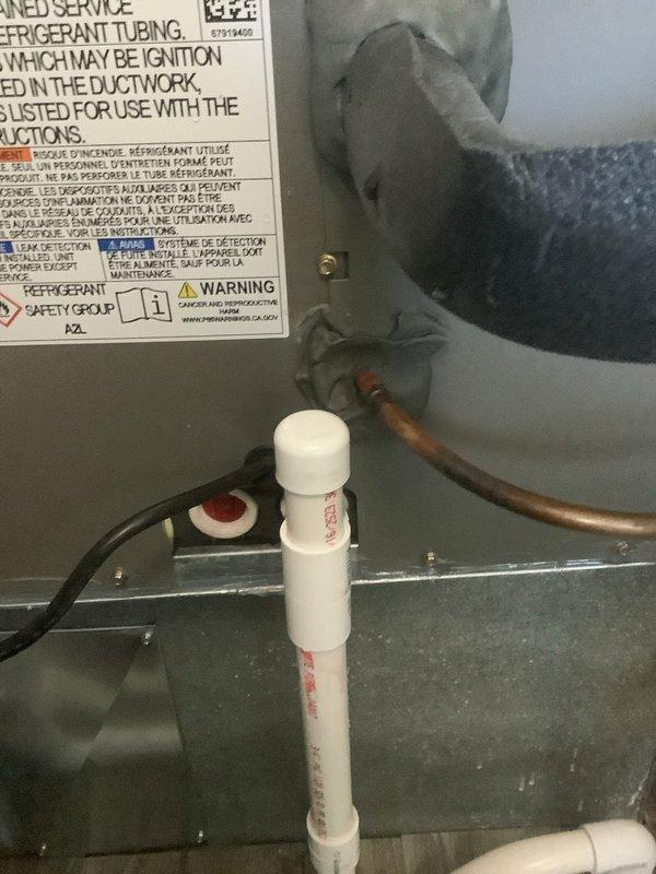 Responded to service call for water leaking from newly installed air conditioning unit in laundry room. Upon inspection, identified improper condensate drain line installation with inadequate pitch and connection issues at the PVC drain assembly. Corrected drain line configuration, ensured proper slope for gravity drainage, and secured all connections to eliminate the water leak. System tested and verified no further water discharge from unit.
