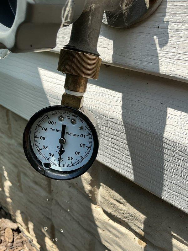 Responded to complaint of loud buzzing noise from pressure regulator valve. Inspected pressure reducing valve, expansion tank, and associated plumbing components installed in April 2024. Verified system pressure readings at exterior gauge and examined interior plumbing assembly including copper supply lines, flow control devices, and mounting hardware. Documented current conditions of pressure regulation system and water supply infrastructure with photographs for service records.