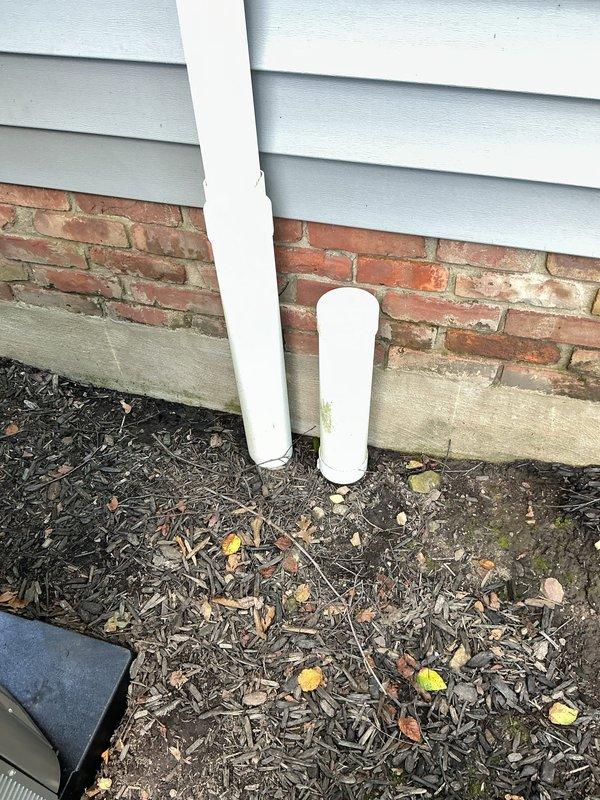 Responded to service call for clogged downspout located near new air conditioning unit. Upon arrival, accessed the drainage system through existing access port and assessed the blockage. Cleared debris and organic material obstructing the downspout flow, ensuring proper water discharge away from the foundation. Verified system functionality and confirmed unobstructed drainage through the PVC discharge line.
