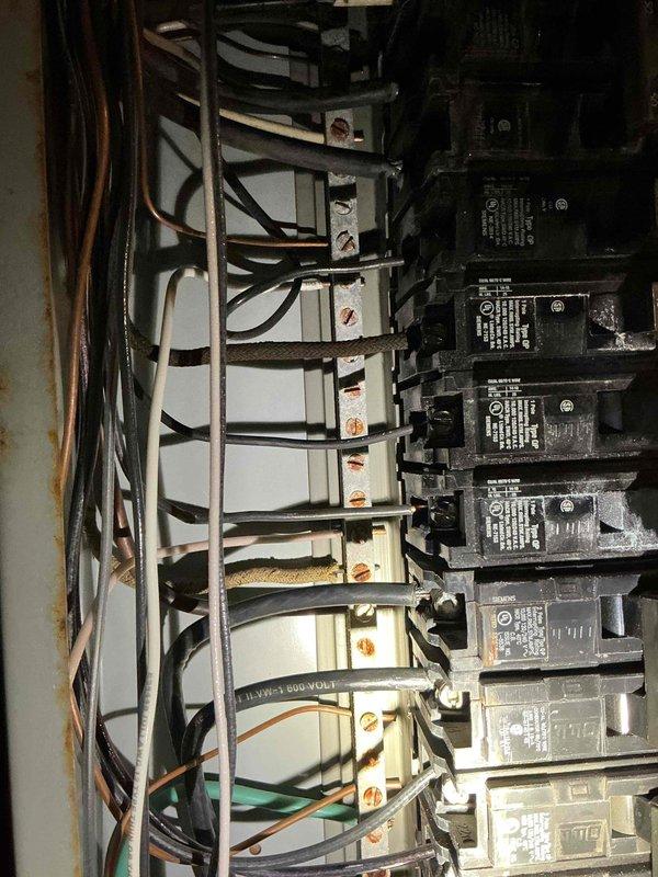 Conducted on-site evaluation for whole house generator installation at residential property originally constructed in late 1920s/early 1930s. Assessed existing electrical infrastructure, including main service panel configuration and current capacity. Documented electrical panel interior showing multiple circuit breakers with organized wire routing. Evaluated compatibility of existing electrical system with proposed generator installation requirements. Property currently utilizes oil heating system, which was factored into load calculations and transfer switch specifications. Photographed panel configuration to support estimate development for automatic transfer switch installation and necessary electrical upgrades to accommodate standby generator system.