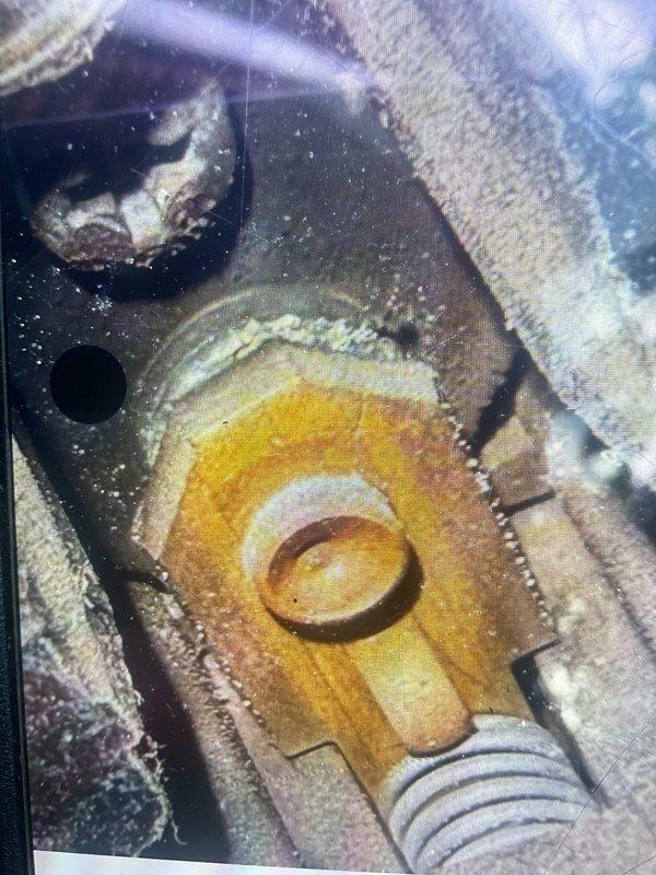 Completed MVP cooling maintenance visit on 15-year-old HVAC system. Performed system diagnostics using digital measurement tools, recording airflow readings of 665 CFM at supply register. Inspection revealed significant dust and debris accumulation on vent louvers and visible surface oxidation on ductwork. Observed heat-related discoloration and oxidation patterns on condensate drain pan, indicating extended thermal exposure consistent with system age. Documented equipment condition with photographic evidence for maintenance records.