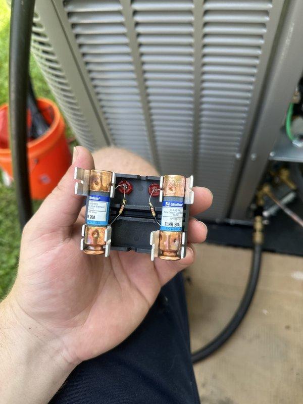 Completed A/C and coil installation as secondary job component. Replaced failed 20A Littelfuse fuses at outdoor condensing unit, which had shown signs of electrical wear and discoloration. New A/C system installed and connected to existing Trane XE 70 furnace with proper refrigerant lines, electrical connections, and condensate drainage. All ductwork connections secured, system tested for proper operation, and unit left running efficiently.