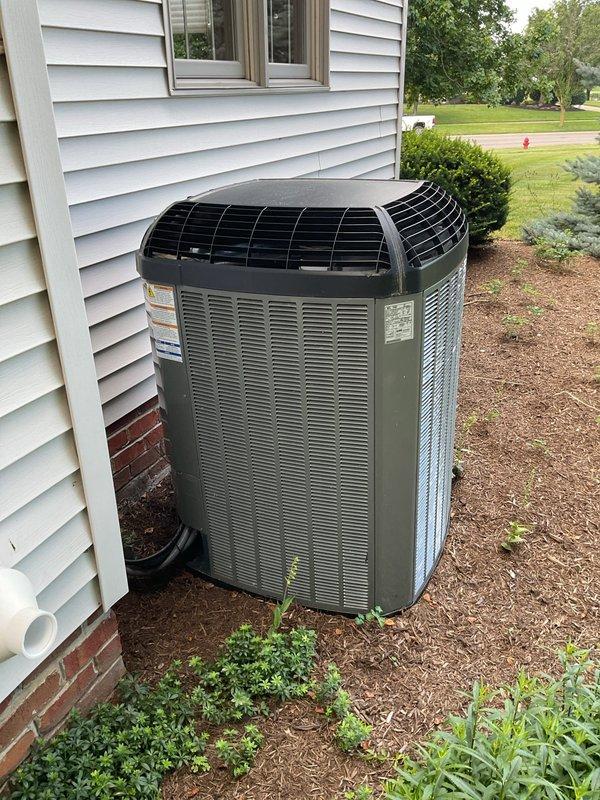 Completed comprehensive tune-up on 13-year-old air conditioning system with heavily soiled evaporator coils showing significant dust, lint, and debris accumulation restricting airflow. Performed standard maintenance protocol including system inspection, cleaning, and operational testing of dual outdoor condenser units, and provided complimentary carbon monoxide detector installation.