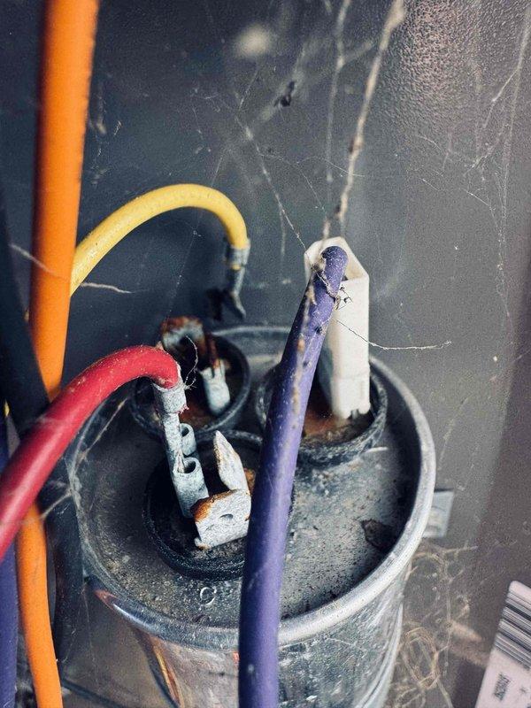 Completed cooling maintenance visit on 8-year-old air conditioning system. Upon inspection, discovered severely deteriorated electrical connector with significant heat damage, charring, and burned plastic housing indicating previous electrical fault or thermal stress event. Multiple wire connections showed advanced corrosion, mineral deposits, and insulation breakdown. Documented all damaged components with photographs for record. System requires immediate electrical repairs to prevent potential failure or safety hazard before unit can be returned to safe operation.