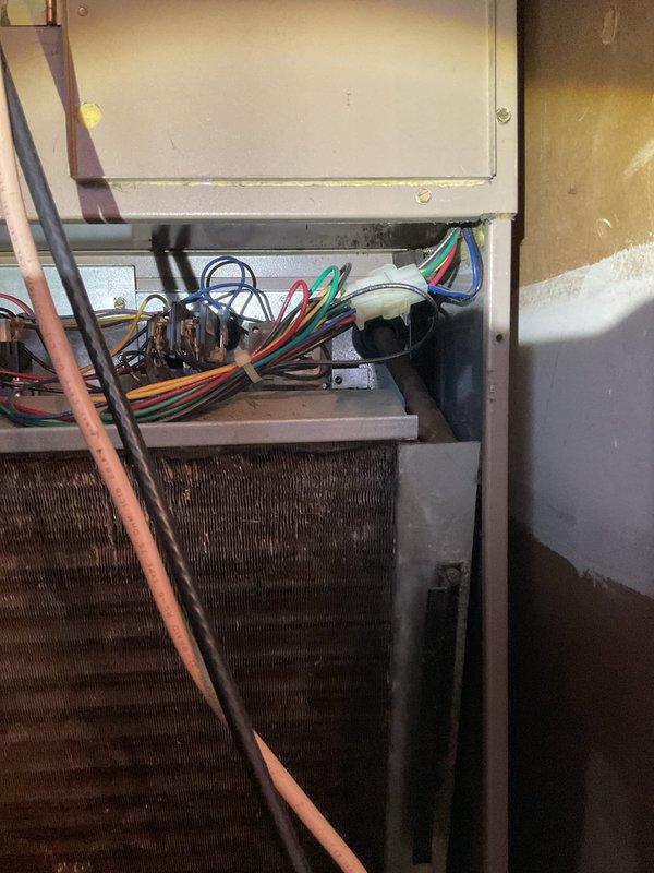Responded to service call for closet-mounted air conditioning unit not cooling properly with suspected refrigerant issue. Upon inspection, found R22 system with heavily soiled evaporator coil restricting airflow and reducing cooling efficiency. Verified electrical connections at control board and capacitor. Documented existing conditions with photos showing dust and debris accumulation on coil fins and internal components. Enrolled customer in maintenance membership program per request.