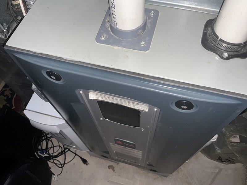Provided comprehensive estimate for high-efficiency furnace replacement system with promotional air conditioning upgrade package. Documented existing HVAC equipment installation including current furnace unit with standard PVC venting configuration, digital control interface, and proper drainage components in basement mechanical room setting.