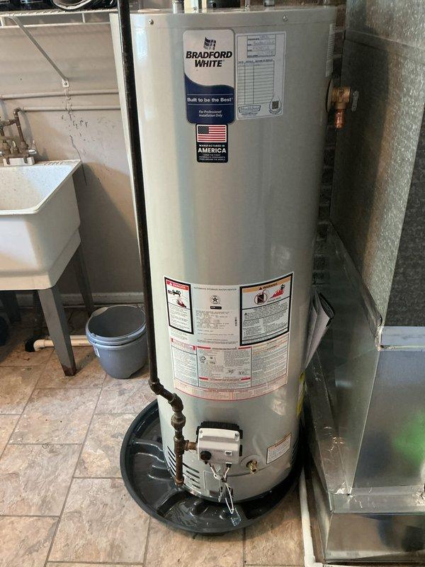 Replaced 40-gallon tall natural gas water heater with new Bradford White unit including required code upgrades. Installation included new drain pan for leak protection, expansion tank to prevent thermal expansion damage to the system, and code-compliant shutoff valve on the cold water supply line. All components were pre-staged and installed to manufacturer specifications with proper connections to existing gas and water lines.