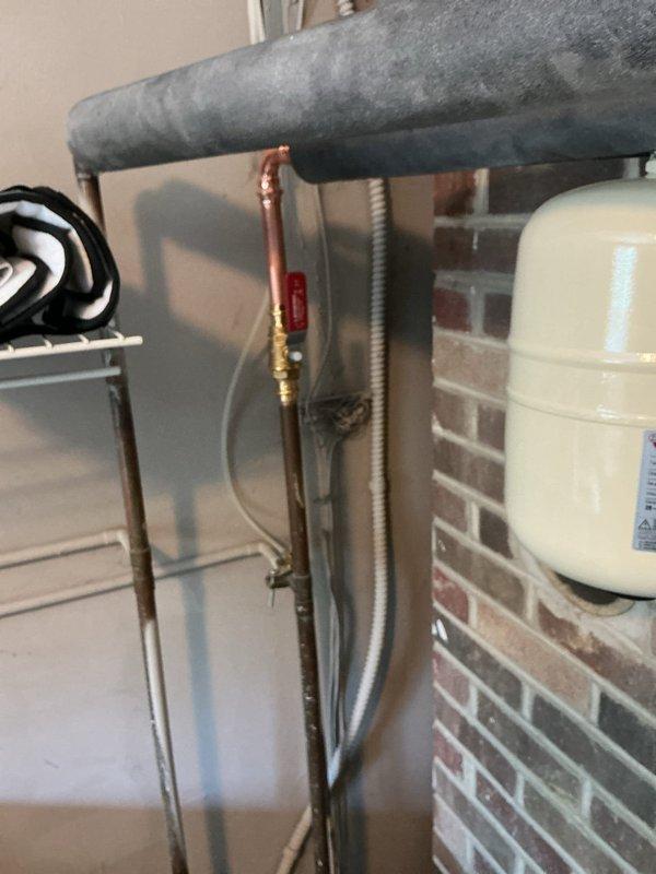 Replaced 40-gallon tall natural gas water heater with new Bradford White unit including required code upgrades. Installation included new drain pan for leak protection, expansion tank to prevent thermal expansion damage to the system, and code-compliant shutoff valve on the cold water supply line. All components were pre-staged and installed to manufacturer specifications with proper connections to existing gas and water lines.