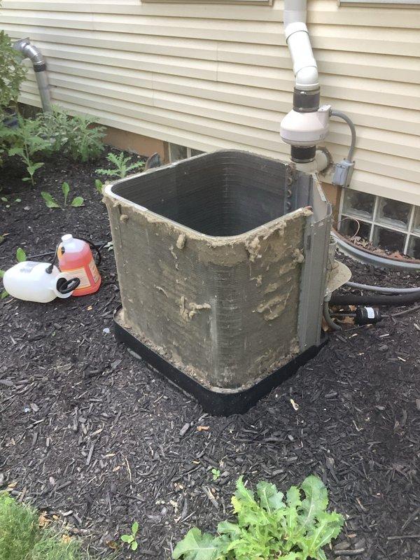 # HVAC Service Report

Responded to service call for 6-year-old air conditioning system not maintaining adequate cooling throughout residence. Upon arrival, performed visual inspection of outdoor condensing unit, which revealed significant deterioration of exterior paint and coating, heavy accumulation of dirt and organic debris on cabinet surfaces, and substantial contamination of condenser coil fins. Unit showed signs of extended environmental exposure with minimal recent maintenance. Documented equipment condition through photographs showing weathered casing, degraded foam insulation at top panel, and greenish-brown patina indicating biological growth. Condenser coil exhibited restricted airflow due to debris buildup between fins. Unit positioned on proper pad with appropriate clearances maintained. Assessed overall system performance and identified maintenance deficiencies contributing to reduced cooling capacity. Provided recommendations for thorough coil cleaning, cabinet restora