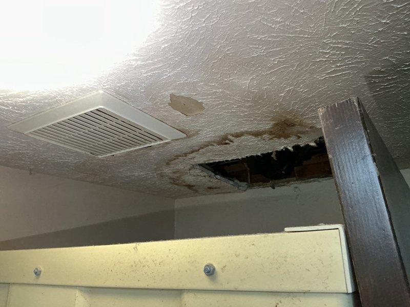 Responded to emergency call for mainline backup in basement. Upon inspection, discovered cracked and deteriorating cast iron sewer line causing sewage backup into residential plumbing system. Backup had resulted in water damage to basement ceiling with visible structural deterioration and staining. Documented extensive damage to ceiling materials and evidence of sewage backup affecting bathroom fixtures on upper level, with visible staining in toilet bowl indicating compromised drainage. Assessed mainline crack location and severity to determine repair scope required for proper system restoration.