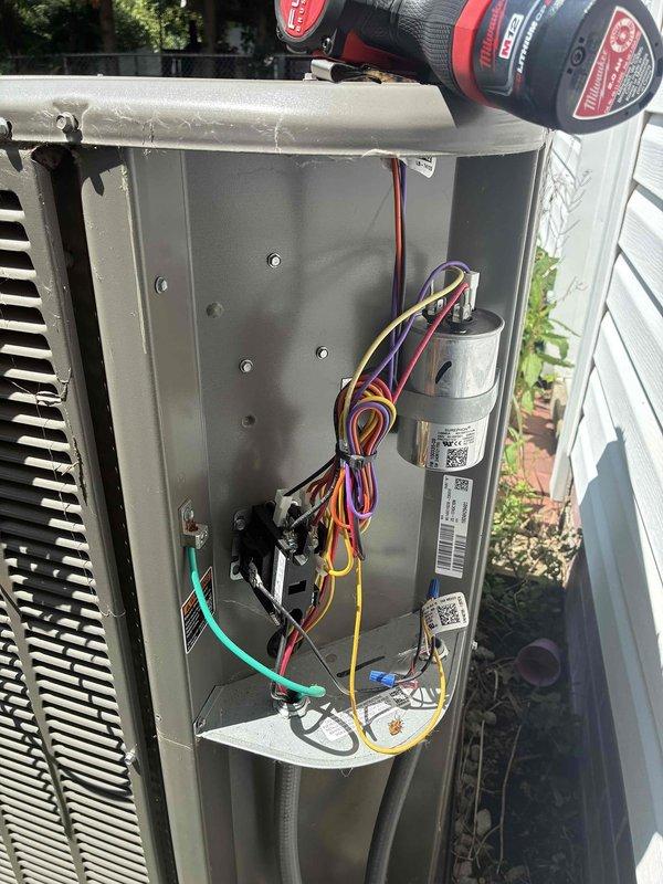 # HVAC Maintenance - Cooling

Completed scheduled MVP cooling maintenance visit on 1-year-old Lennox condensing unit. Removed access panel and inspected internal electrical components including dual capacitors, contactors, and associated wiring connections. All electrical connections were verified secure with proper wire routing observed throughout the system. Capacitors showed no signs of bulging or leakage, indicating proper operation within expected parameters for equipment age.

Examined outdoor unit positioned on concrete pad with noted vegetation encroachment around base and sides of condenser. Exterior coil grille and top fan guard inspected and found intact with no physical damage. Unit maintained adequate clearance from structure despite surrounding landscaping requiring monitoring for future airflow considerations.

System operational and functioning as designed. All components within normal operating specifications for routine preventive maintenance service.