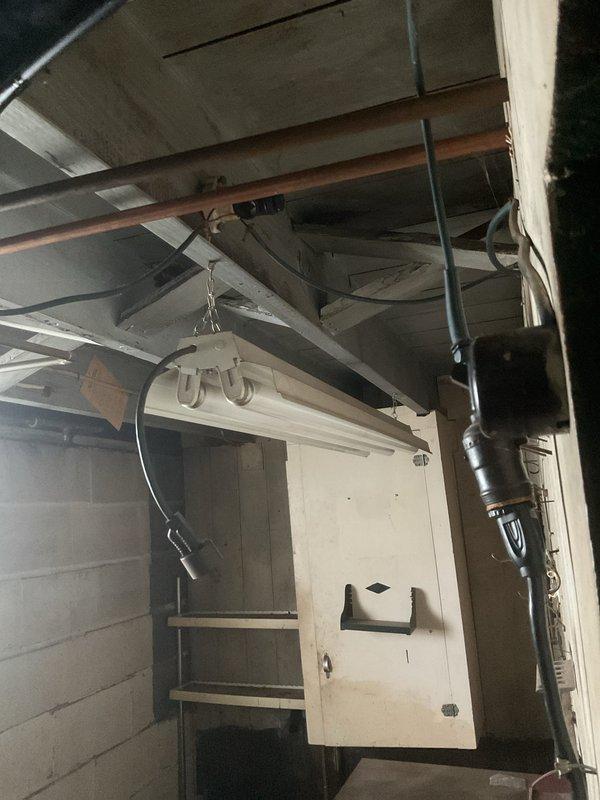Provided electrical estimate for fixture installation work in attic storage space and stairwell area. Assessment included evaluation of existing exposed conduit runs, flexible conduit routing, and structural mounting requirements for proper fixture placement in accordance with code requirements. Quote encompasses installation specifications for adequate lighting coverage in upper-level access areas with consideration for existing cabinet ventilation systems and structural beam clearances.