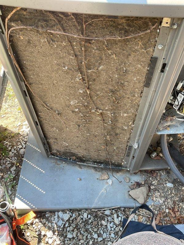 Responded to no cooling complaint at main residence. Upon inspection, found outdoor condensing unit with severely neglected maintenance conditions. Air filter and evaporator coil exhibited heavy accumulation of dirt, dust, and debris, restricting airflow and reducing system efficiency. External cabinet showed significant weathering with extensive cobweb buildup indicating prolonged lack of service. Removed and cleaned heavily soiled filter, cleared debris from unit base and surrounding area. Inspected refrigerant lines and internal components for proper operation. System restored to normal cooling operation. Customer enrolled in preventative maintenance program to ensure regular service intervals and prevent future performance issues.