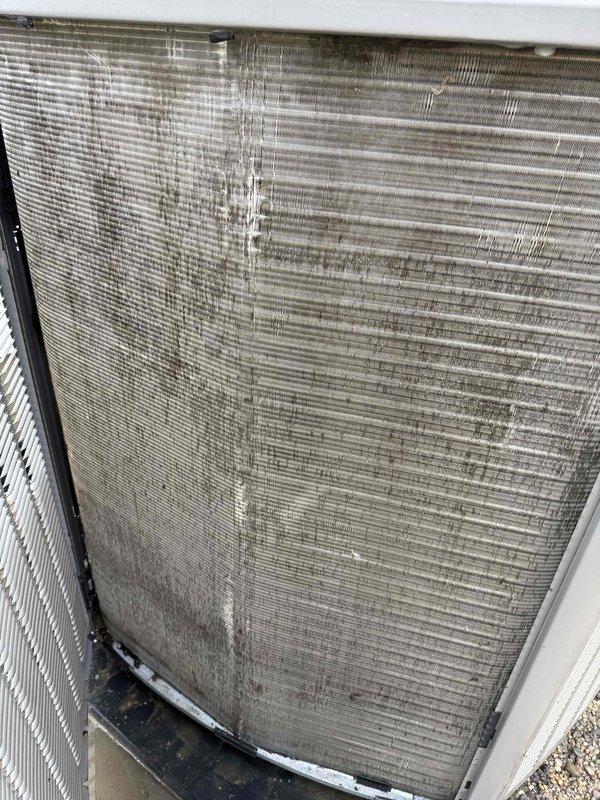# HVAC Service Report

Responded to no-cooling complaint on 5-year-old residential AC system affecting entire home. Upon inspection, found exterior condensing unit filter and condenser coil heavily contaminated with dirt, dust, and debris buildup, significantly restricting airflow and reducing system efficiency. Removed and cleaned exterior filter, which showed substantial dust accumulation and discoloration from extended use without maintenance. Thoroughly cleaned condenser coil fins, removing thick layers of accumulated particulate matter that had embedded between the horizontal fins, particularly concentrated on the left and center portions of the coil. Heavy contamination was preventing proper heat exchange and causing system to fail cooling. After cleaning both components, verified adequate airflow through condenser unit and confirmed system restored to normal cooling operation. Documented condition with photos showing before-cleaning state of filter and coil. Advised homeowner on
