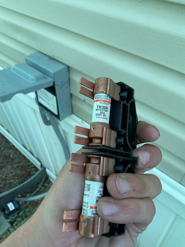 Responded to no cooling complaint with unit running but not providing adequate cooling, indoor temperature reading 80°F or higher. Upon inspection, discovered blown fuses in outdoor condensing unit preventing compressor operation while fan motor continued to run. Replaced failed TR30R 250V AC fuses in fuse holder assembly and verified proper amperage rating. Confirmed supply air temperature at register reading 68°F after repair, restoring normal cooling operation to system.