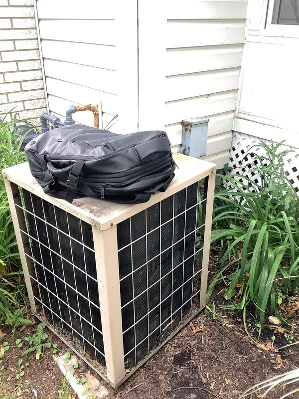 Conducted site evaluation and provided replacement estimate for 30-year-old residential HVAC system consisting of gas furnace and air conditioning unit. System was originally oil-fired and converted to natural gas, currently operational but nearing end of service life. Inspected outdoor condenser unit with beige metal cabinet and assessed refrigerant line routing along exterior siding. Evaluated indoor furnace installation in utility space and documented existing ductwork configuration. Photographed equipment conditions and system components to support replacement proposal recommendations.